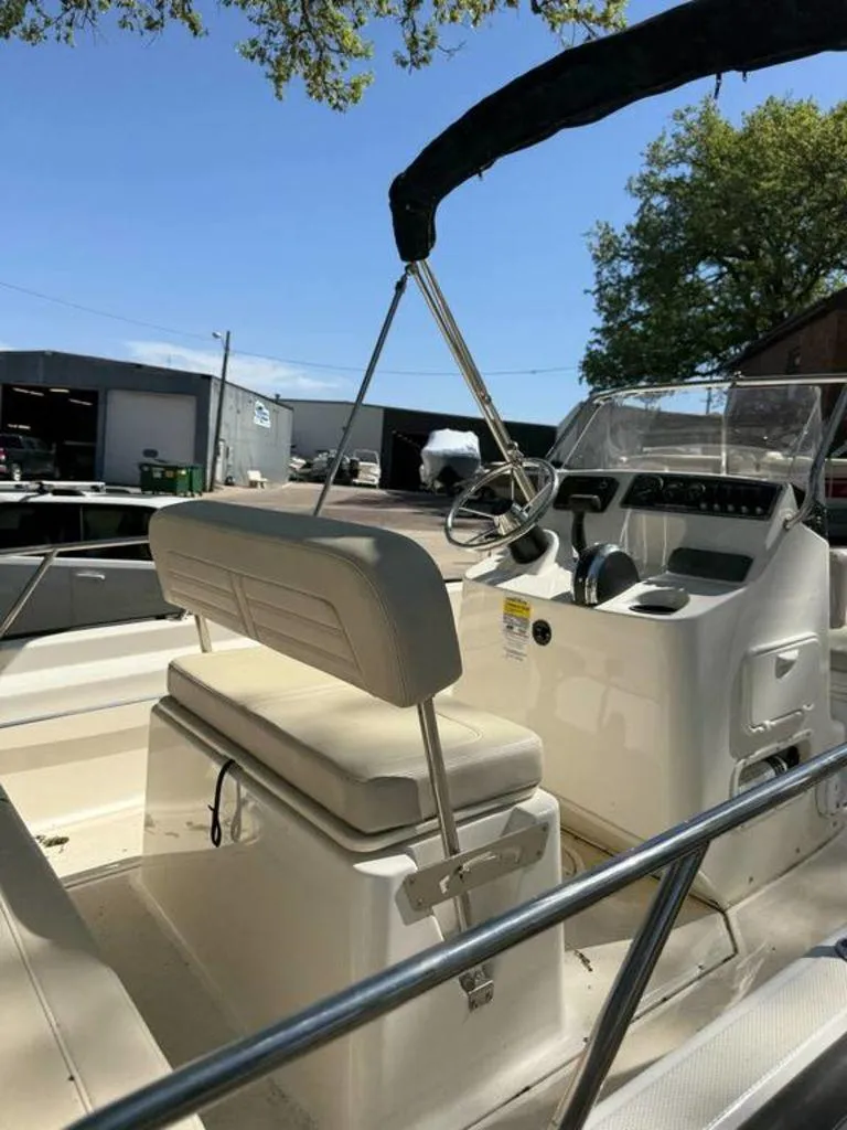 Slide: The Image of 2020 Boston Whaler 170 Montauk boat interior with steering console and seating. - 3