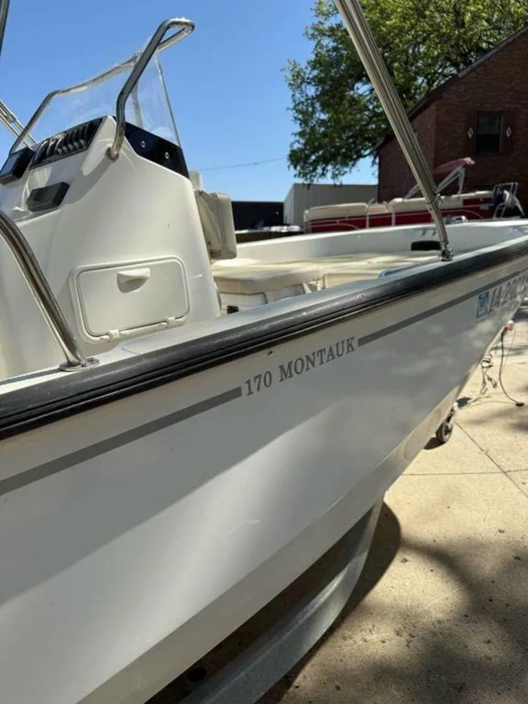 Slide: The Image of 2020 Boston Whaler 170 Montauk boat, side view, parked outdoors. - 5