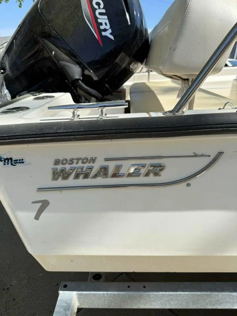 Slide: The Image of 2020 Boston Whaler 170 Montauk boat with Mercury engine, side view. - 6