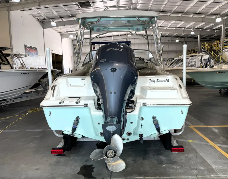 Slide: The Image of 2024 Key West 239 DFS boat in a showroom, featuring a powerful outboard motor. - 11