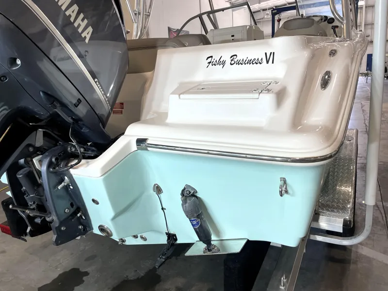 Slide: The Image of 2024 Key West 239 DFS boat with Yamaha engine, named "Fishy Business VI," in a showroom. - 13