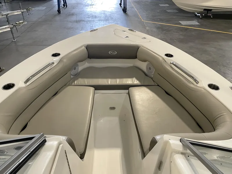 Slide: The Image of 2024 Key West 239 DFS boat interior with cushioned seating and cup holders. - 18