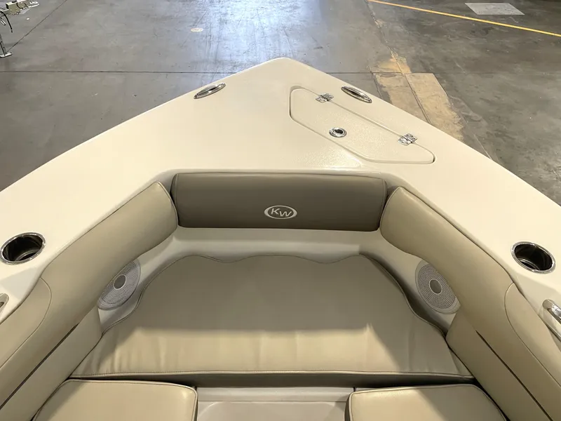 Slide: The Image of 2024 Key West 239 DFS boat interior with cushioned seating and cup holders. - 19