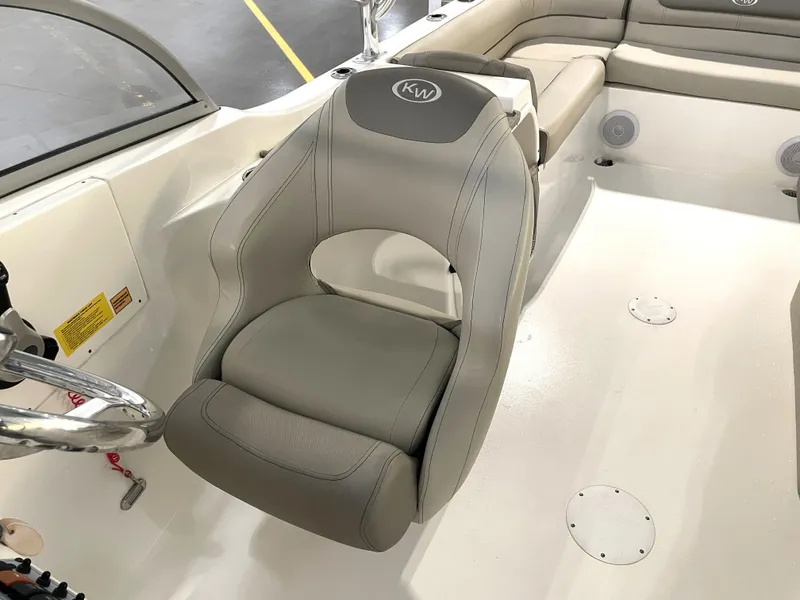 Slide: The Image of 2024 Key West 239 DFS boat interior with gray seating and steering wheel. - 22