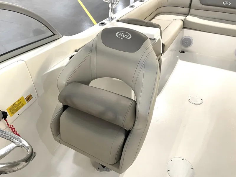 Slide: The Image of 2024 Key West 239 DFS boat interior with gray seating and steering area. - 23