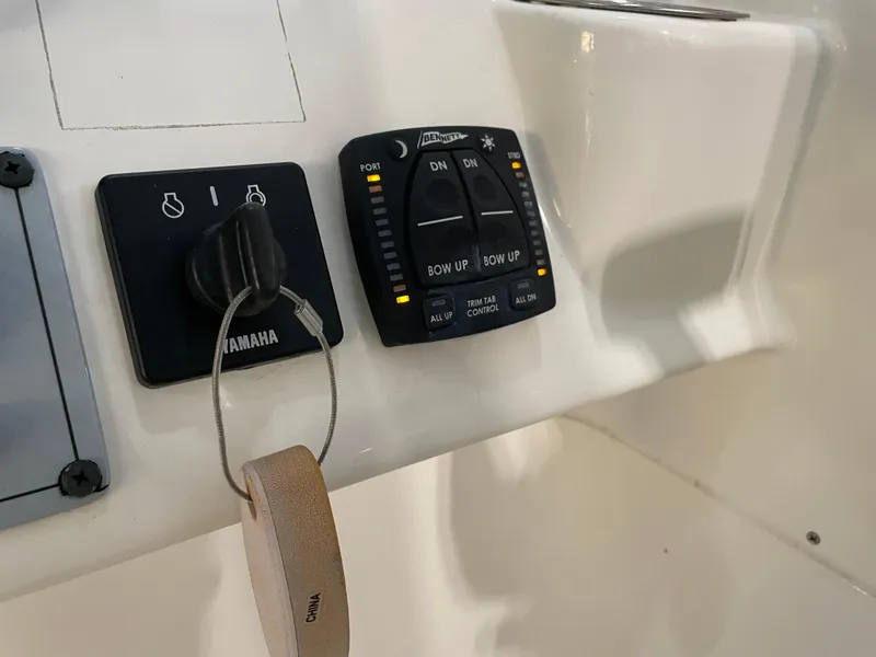 Slide: The Image of 2024 Key West 239 DFS boat controls with Yamaha ignition and trim tab panel. - 28