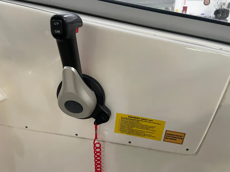 Slide: The Image of Throttle control lever on 2024 Key West 239 DFS boat dashboard with safety checklist. - 29