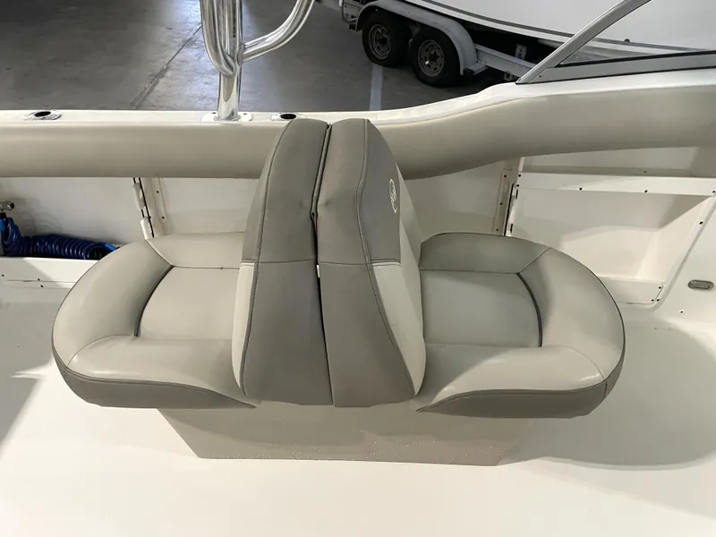 Slide: The Image of 2024 Key West 239 DFS boat interior with dual gray seats in a showroom. - 32
