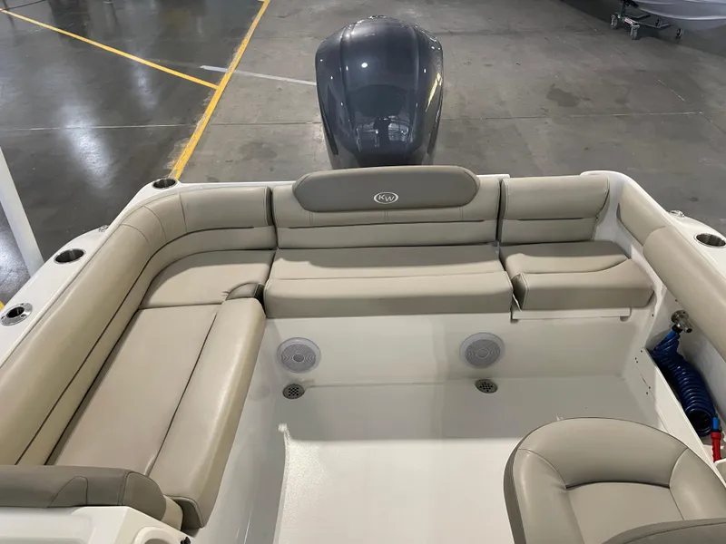 Slide: The Image of 2024 Key West 239 DFS boat interior with beige seating and outboard motor. - 34