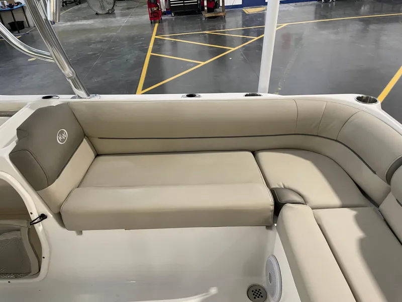 Slide: The Image of 2024 Key West 239 DFS boat interior with beige seating and cup holders. - 35