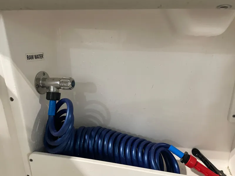 Slide: The Image of 2024 Key West 239 DFS raw water hose setup with coiled blue hose. - 36