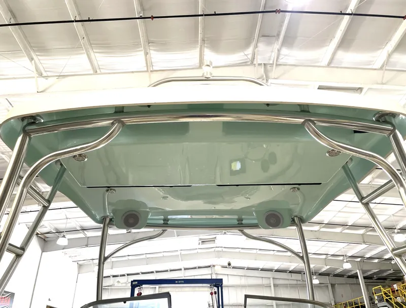 Slide: The Image of 2024 Key West 239 DFS boat canopy with stainless steel frame in a warehouse setting. - 39