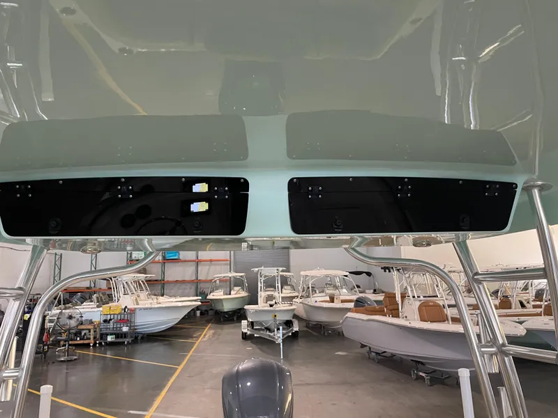 Slide: The Image of 2024 Key West 239 DFS boat interior in showroom with multiple boats in background. - 40