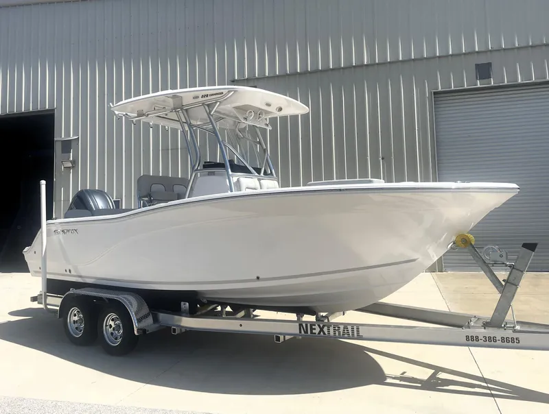 Slide: The Image of 2023 Sea Fox 228 Commander boat on trailer outside industrial building. - 2