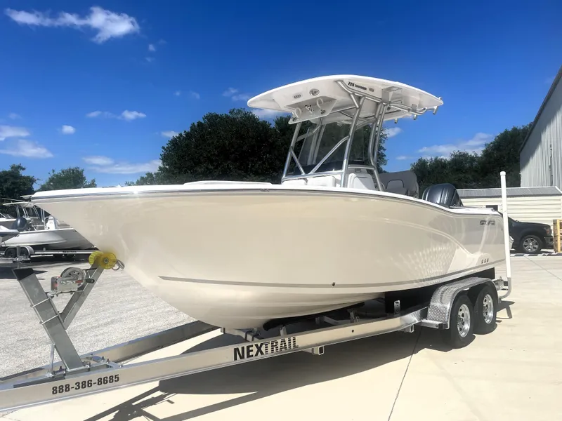 Slide: The Image of 2023 Sea Fox 228 Commander boat on trailer under clear blue sky. - 3