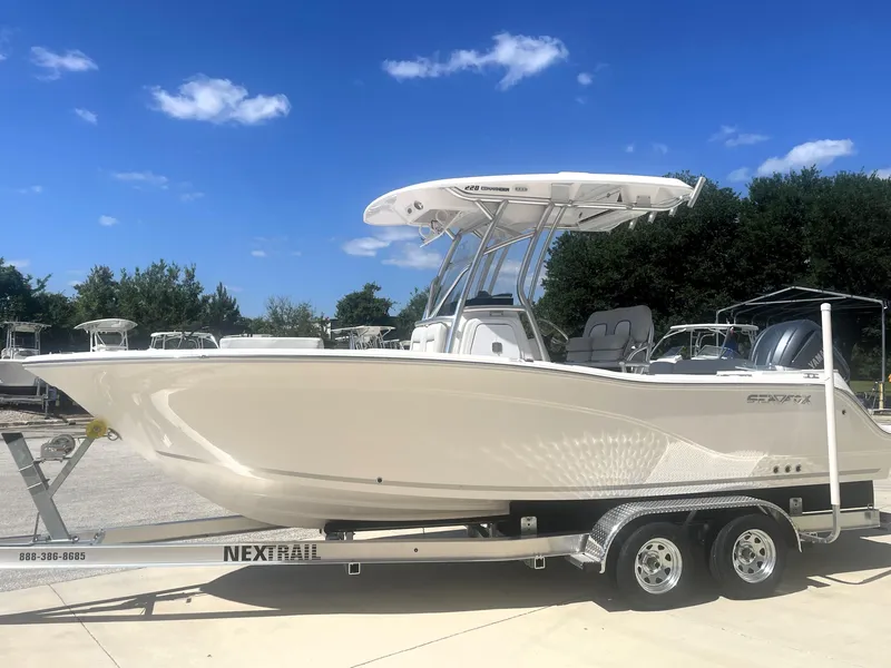 Slide: The Image of 2023 Sea Fox 228 Commander boat on trailer under clear blue sky. - 4