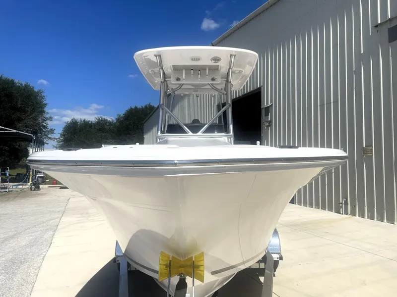 Slide: The Image of 2023 Sea Fox 228 Commander boat on trailer, parked outside a metal building. - 8