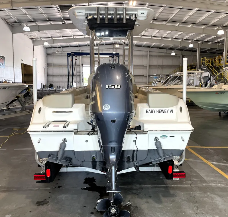 Slide: The Image of 2023 Key West 203 FS boat with Yamaha 150 engine in a storage facility. - 10