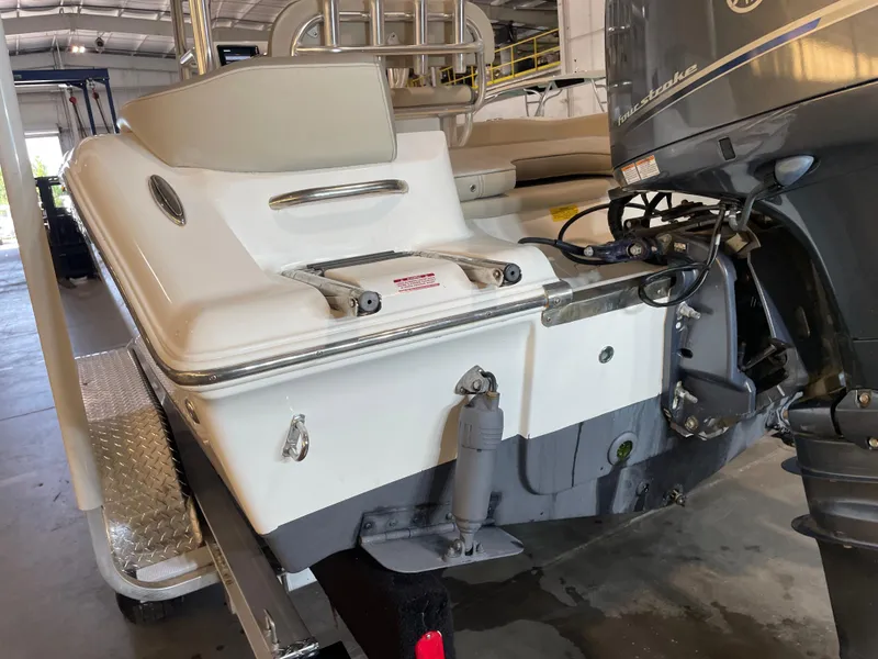Slide: The Image of 2023 Key West 203 FS boat with outboard motor in a garage setting. - 11