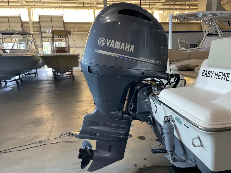 Slide: The Image of 2023 Key West 203 FS boat with Yamaha outboard motor in a showroom. - 13