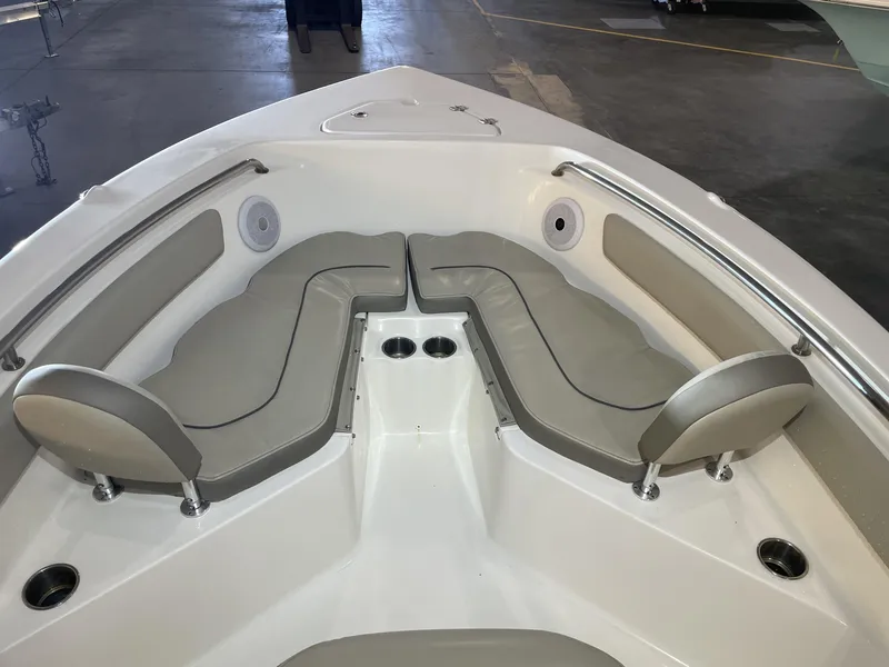 Slide: The Image of 2023 Key West 203 FS boat interior with cushioned seating and cup holders. - 15