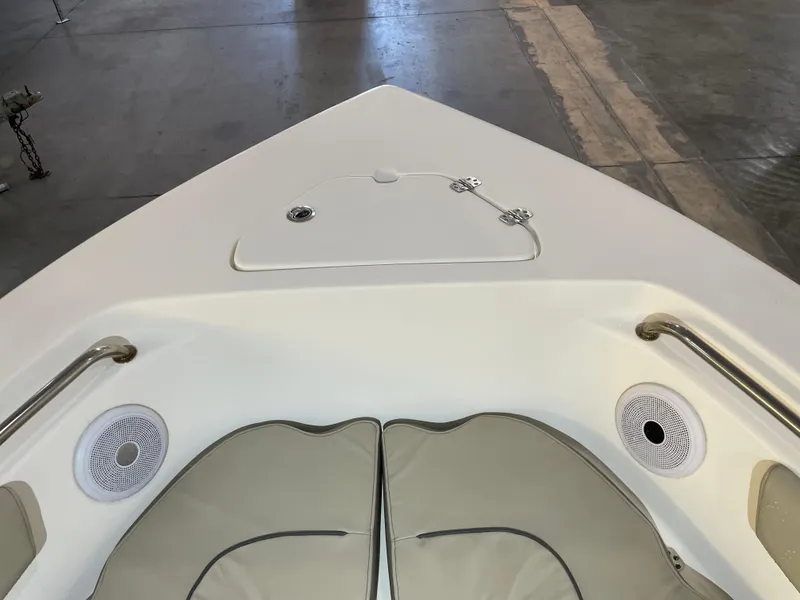 Slide: The Image of 2023 Key West 203 FS boat interior with cushioned seating and speakers. - 18