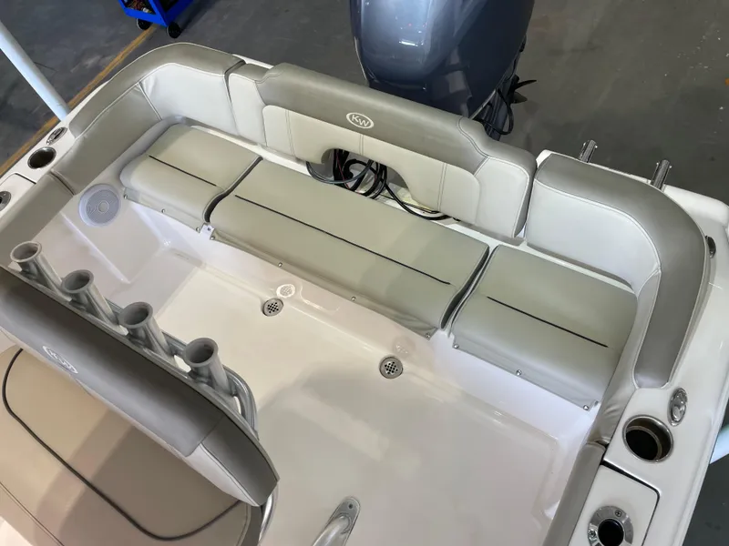 Slide: The Image of 2023 Key West 203 FS boat interior with cushioned seating and rod holders. - 32
