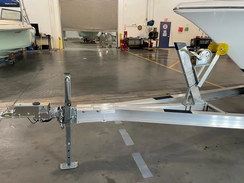 Slide: The Image of 2023 Key West 203 FS boat trailer in a garage setting. - 38