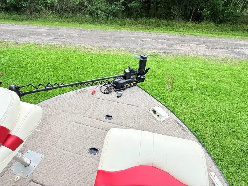 Slide: The Image of 2005 Lowe Suncruiser boat deck with trolling motor and seating, on grassy area. - 12