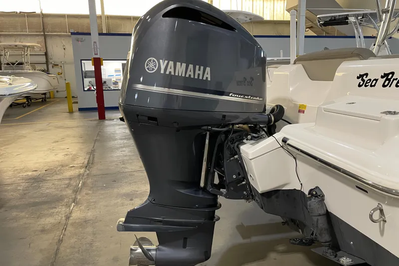 Slide: The Image of 2023 Key West 239 DFS boat with Yamaha four-stroke outboard engine in a garage. - 14