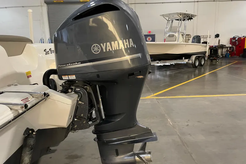 Slide: The Image of 2023 Key West 239 DFS boat with Yamaha 250 engine in a showroom. - 15