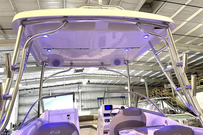 Slide: The Image of 2023 Key West 239 DFS boat with T-top and blue LED lights in a showroom. - 17