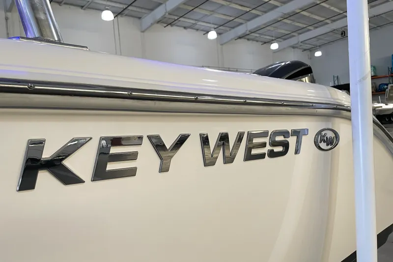 Slide: The Image of 2023 Key West 239 DFS boat interior with beige seating and stainless steel accents. - 19