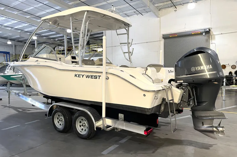 Slide: The Image of 2023 Key West 239 DFS boat in showroom, featuring sleek design and spacious seating. - 6
