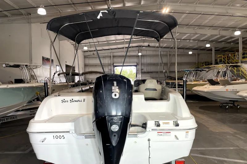 Slide: The Image of 2022 Hurricane SunDeck Sport 201 OB boat interior with beige seating and cup holders. - 12