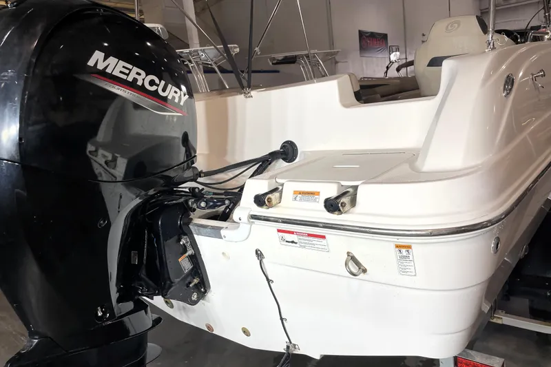 Slide: The Image of 2022 Hurricane SunDeck Sport 201 OB boat interior with beige seating and storage compartments. - 14