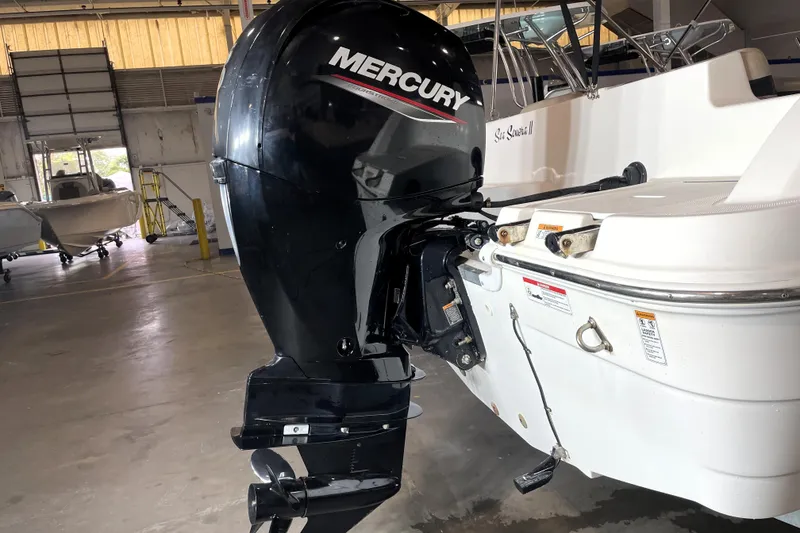 Slide: The Image of 2022 Hurricane SunDeck Sport 201 OB boat interior with beige seating and cup holders. - 15