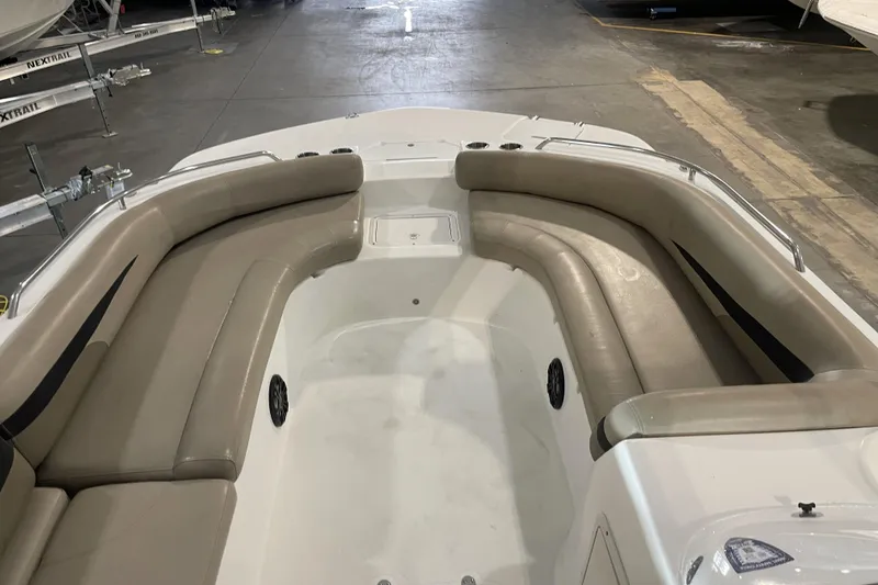 Slide: The Image of 2022 Hurricane SunDeck Sport 201 OB boat interior with beige seating and cup holders. - 18