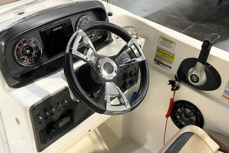 Slide: The Image of 2022 Hurricane SunDeck Sport 201 OB boat interior with beige seating and storage compartment. - 25