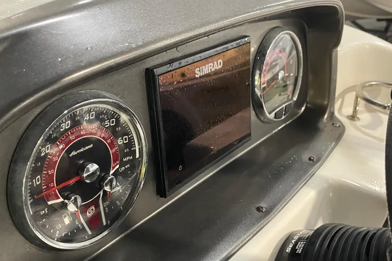 Slide: The Image of 2022 Hurricane SunDeck Sport 201 OB boat interior with seating and storage compartments. - 26