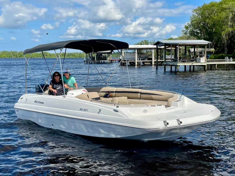 Slide: The Image of 2022 Hurricane SunDeck Sport 201 OB boat on trailer, parked outside a warehouse. - 3