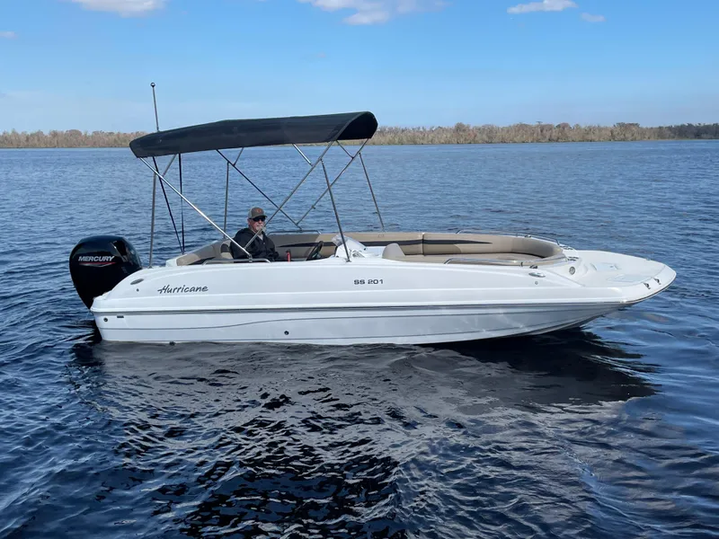Slide: The Image of 2022 Hurricane SunDeck Sport 201 OB boat with Mercury engine on trailer. - 4