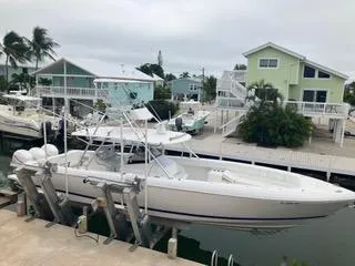 Slide: The Image of 2016 Intrepid 400 Center Console boat docked near waterfront homes. - 1