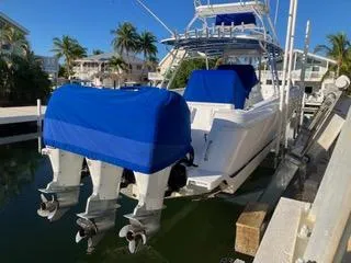 Slide: The Image of 2016 Intrepid 400 Center Console boat docked with blue engine covers. - 10