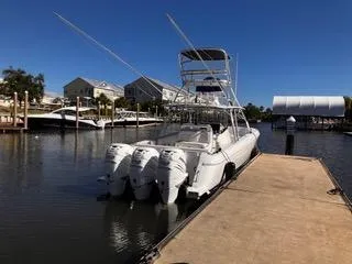 Slide: The Image of 2016 Intrepid 400 Center Console boat docked at marina with four outboard engines. - 11