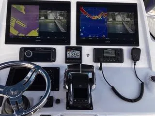 Slide: The Image of Control panel of a 2016 Intrepid 400 Center Console with navigation screens and steering wheel. - 12