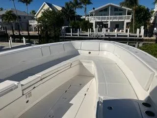 Slide: The Image of 2016 Intrepid 400 Center Console boat docked near waterfront homes. - 13