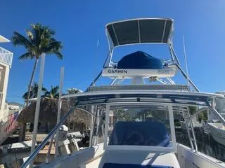 Slide: The Image of 2016 Intrepid 400 Center Console boat docked under clear blue sky. - 15