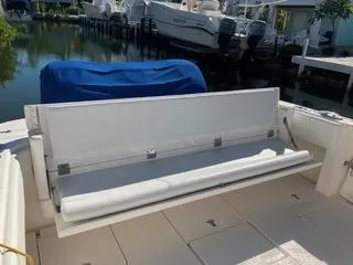 Slide: The Image of 2016 Intrepid 400 Center Console boat with foldable seating, docked near other boats. - 17