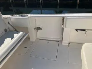 Slide: The Image of 2016 Intrepid 400 Center Console boat interior with storage compartments and seating. - 18